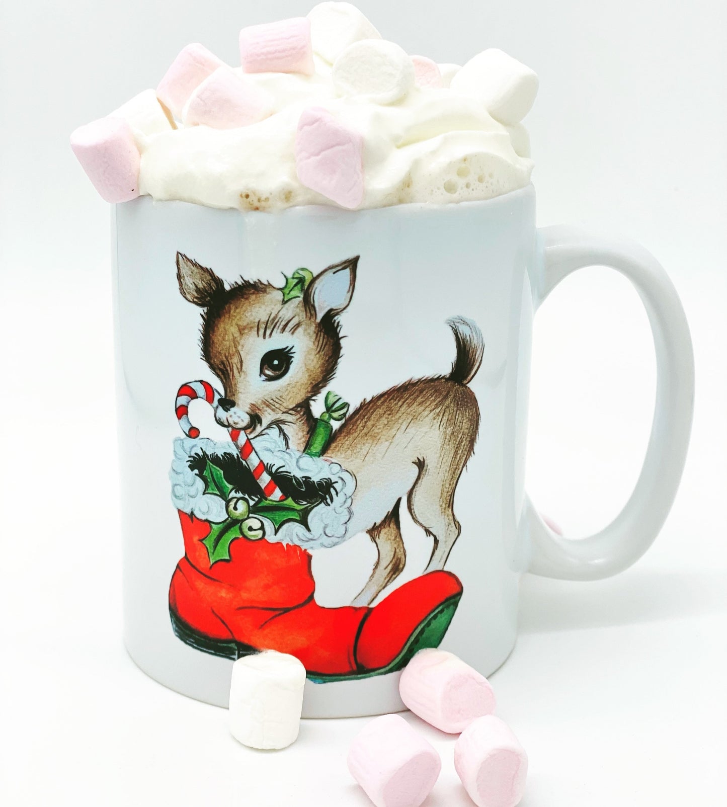 Christmas mug featuring a cute, hand drawn reindeer with a candy cane in her mouth and a Santa boot at her feet.