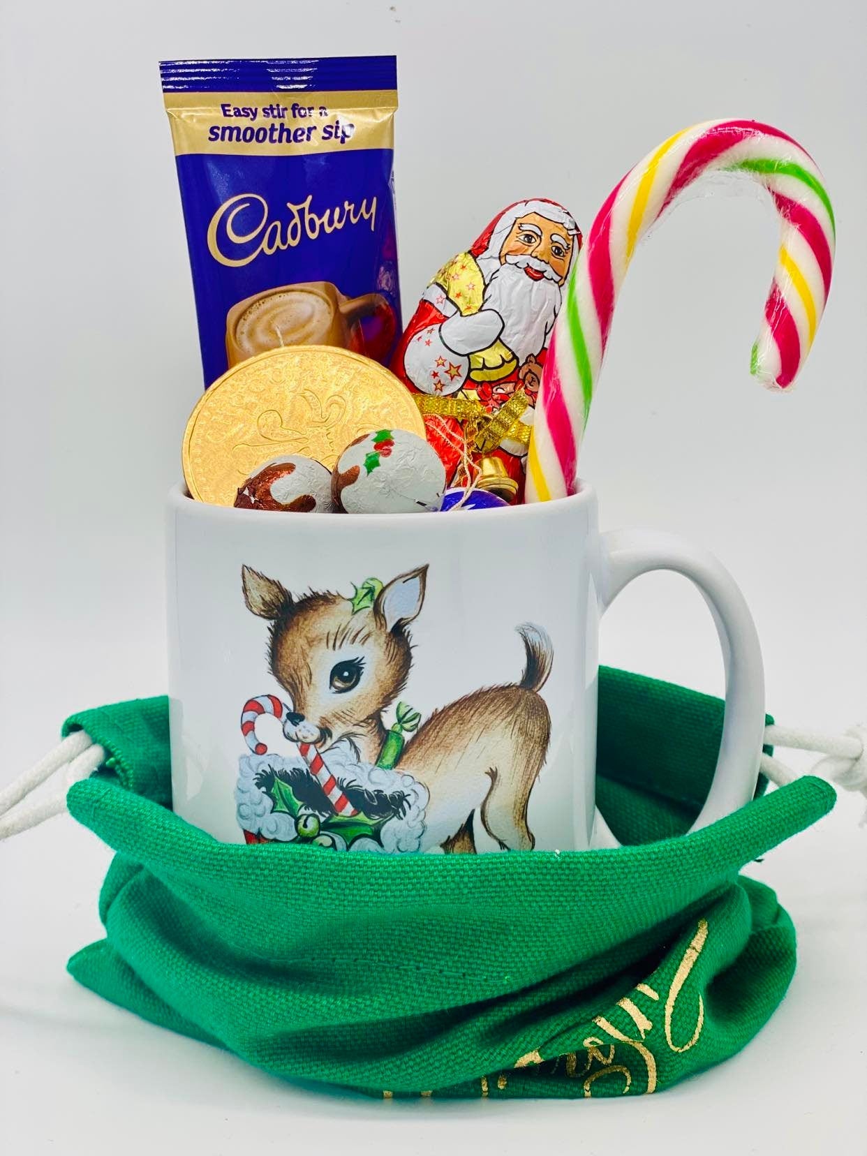 Christmas mug filled with chocolates in a Santa sack.